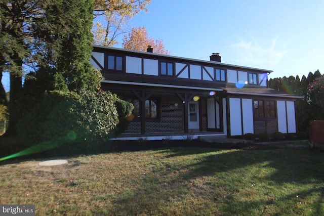 rear view of property featuring a yard