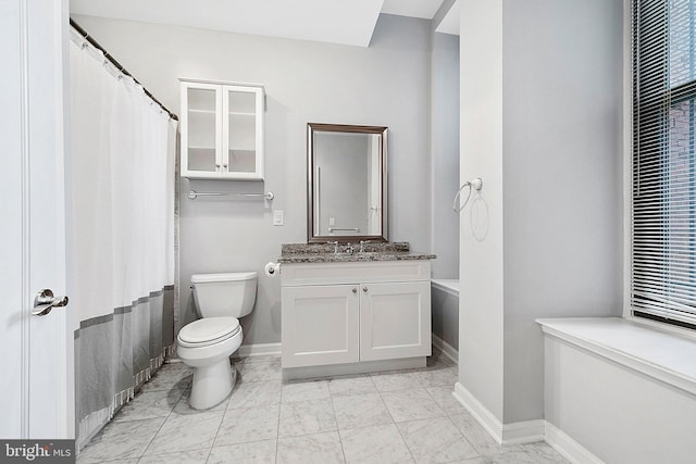 full bathroom featuring toilet, shower / tub combo with curtain, and vanity