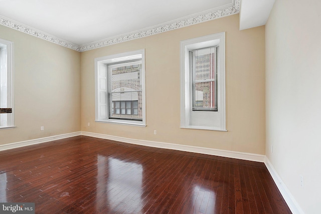 unfurnished room with crown molding, wood-type flooring, and a wealth of natural light