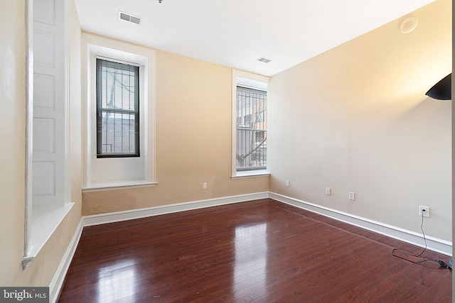 empty room with dark wood-type flooring