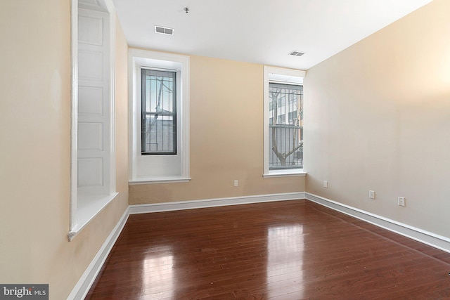 unfurnished room featuring dark hardwood / wood-style floors