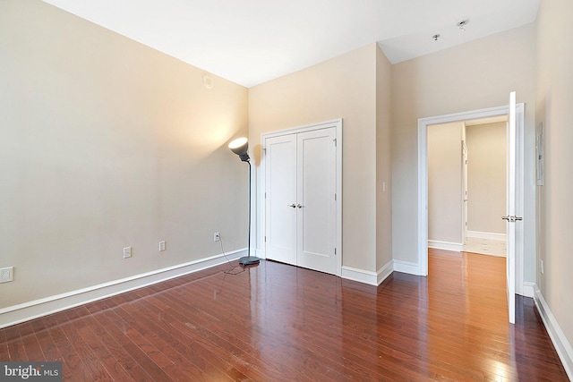 unfurnished bedroom with dark hardwood / wood-style floors