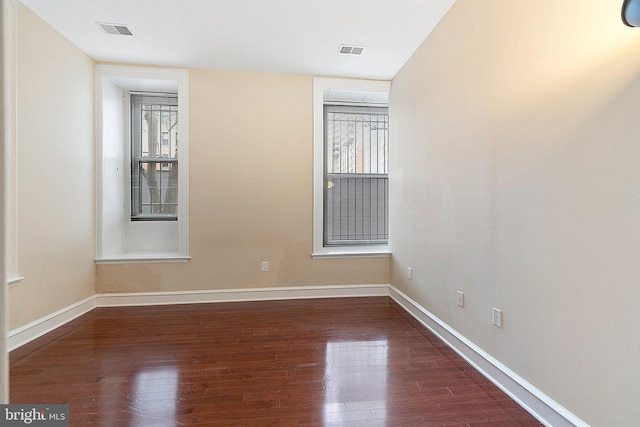 unfurnished room featuring dark hardwood / wood-style floors