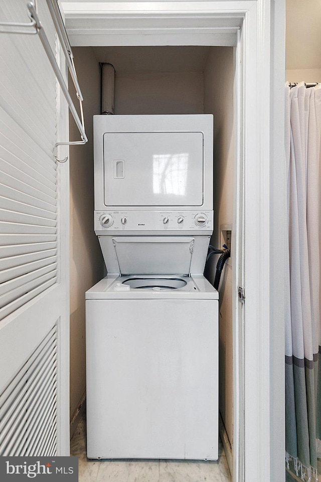 laundry room with stacked washer / dryer