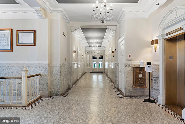 corridor featuring crown molding, a high ceiling, a chandelier, and elevator