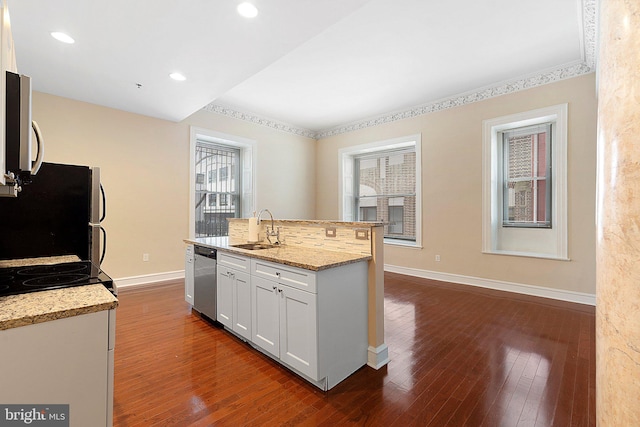 kitchen featuring stainless steel appliances, sink, light stone countertops, white cabinetry, and dark hardwood / wood-style flooring