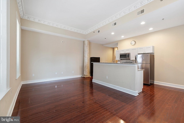 kitchen featuring appliances with stainless steel finishes, light stone counters, white cabinetry, and dark hardwood / wood-style flooring