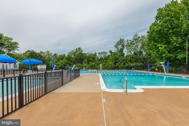 pool featuring a patio area and fence