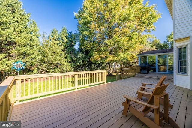 wooden deck with a lawn