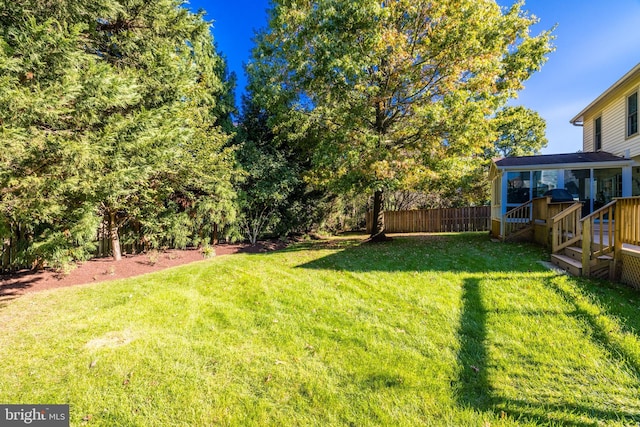 view of yard with fence and a deck