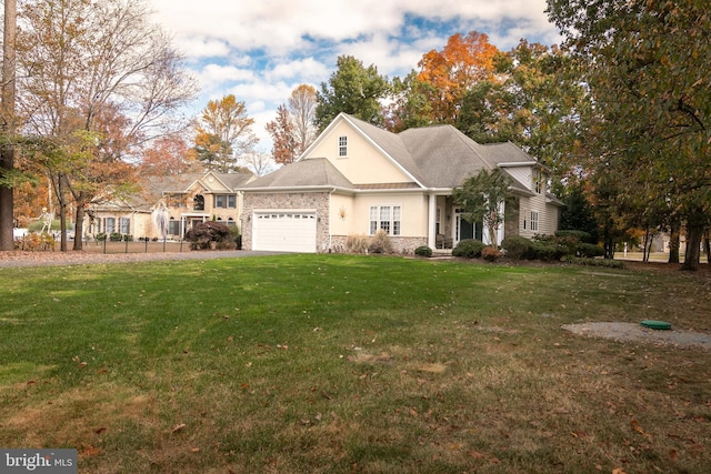 view of front of property with a front lawn and a garage