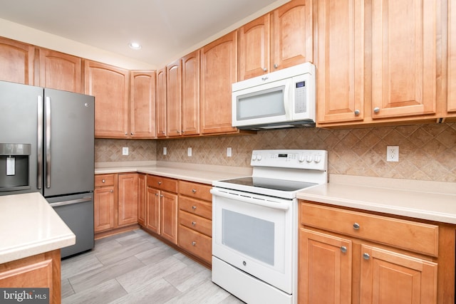 kitchen with white appliances and tasteful backsplash