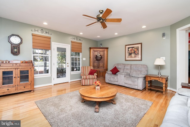 living room featuring ceiling fan and light wood-type flooring