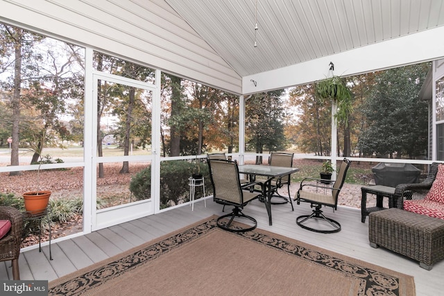 sunroom / solarium featuring lofted ceiling and wooden ceiling