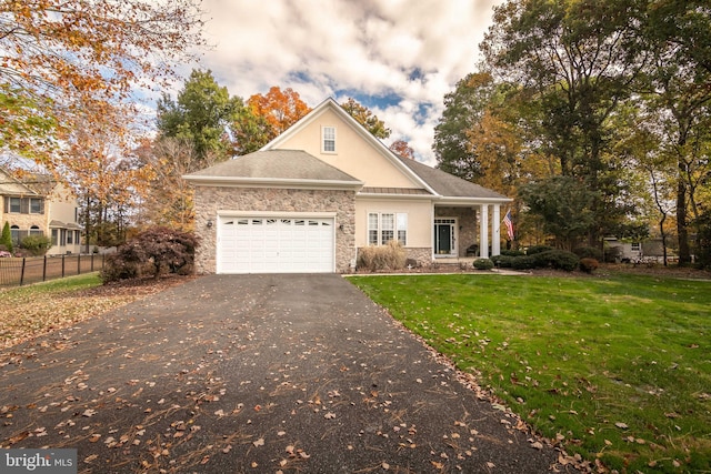 view of front of house with a garage and a front lawn