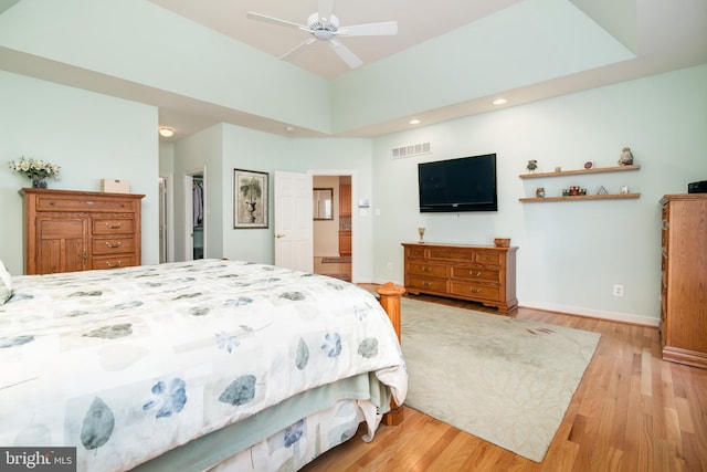 bedroom with light hardwood / wood-style flooring and ceiling fan