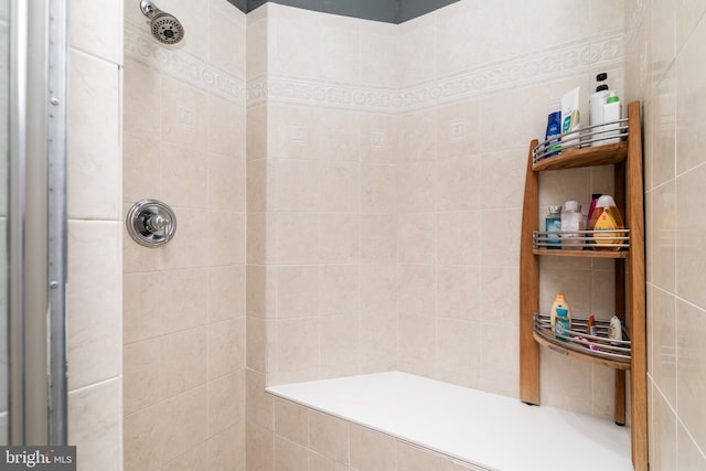 bathroom with a tile shower