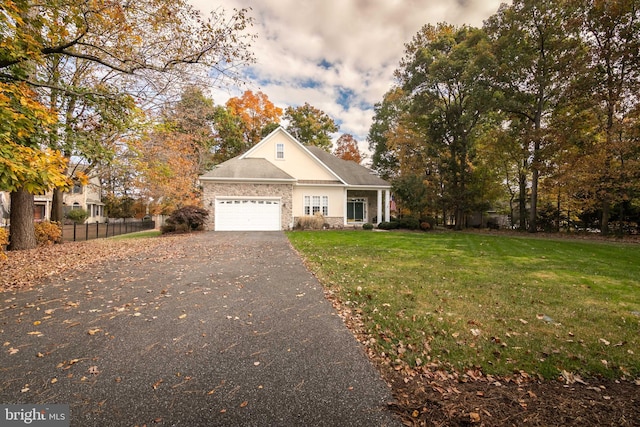 view of front of property featuring a garage and a front yard