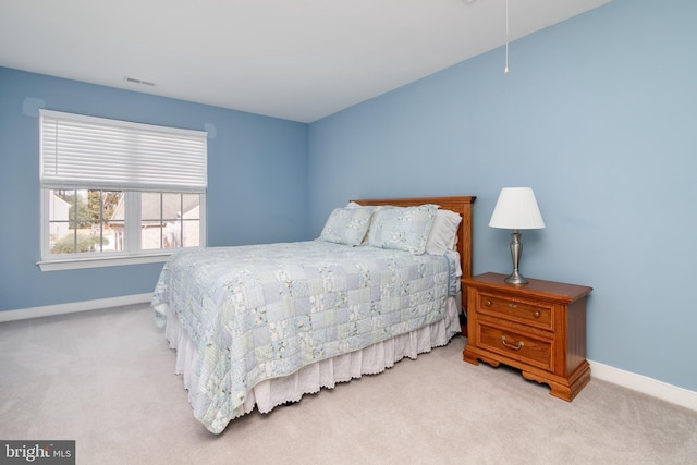 bedroom with light colored carpet