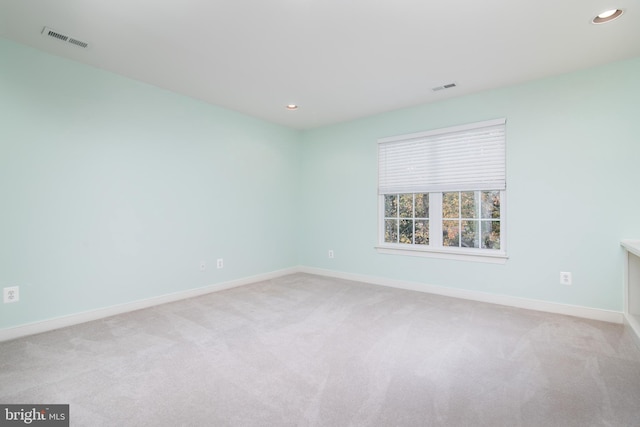 unfurnished room featuring light colored carpet