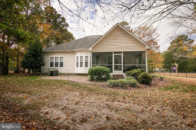 back of property with a sunroom