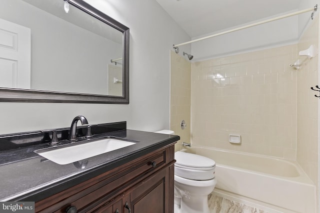 full bathroom featuring toilet, tiled shower / bath combo, and vanity