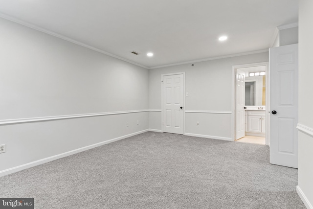 carpeted empty room featuring crown molding