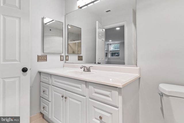 bathroom featuring vanity and toilet