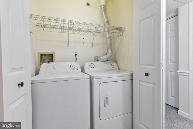 laundry room with washing machine and dryer and carpet flooring