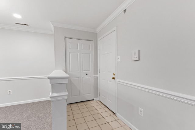 interior space with ornamental molding and light tile patterned floors