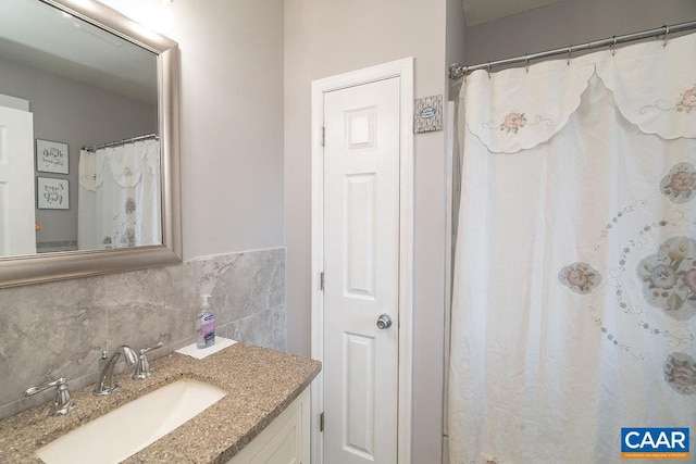 bathroom with vanity and tasteful backsplash