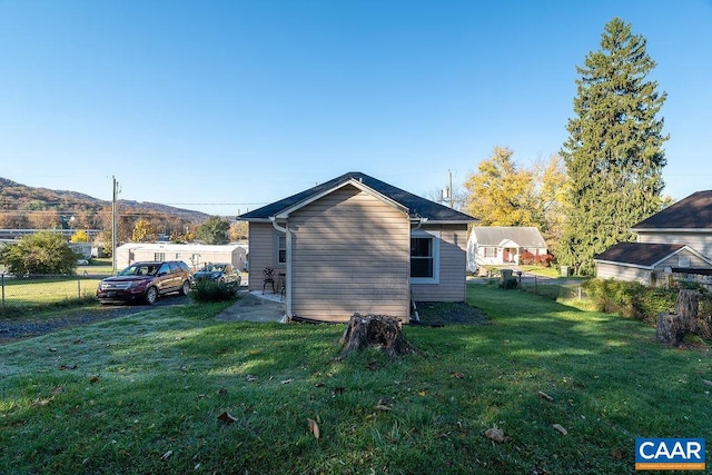 view of home's exterior featuring a mountain view and a yard