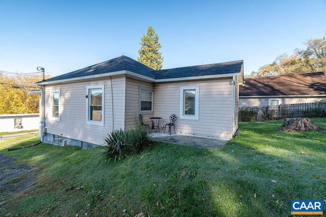 back of house with a yard and a patio