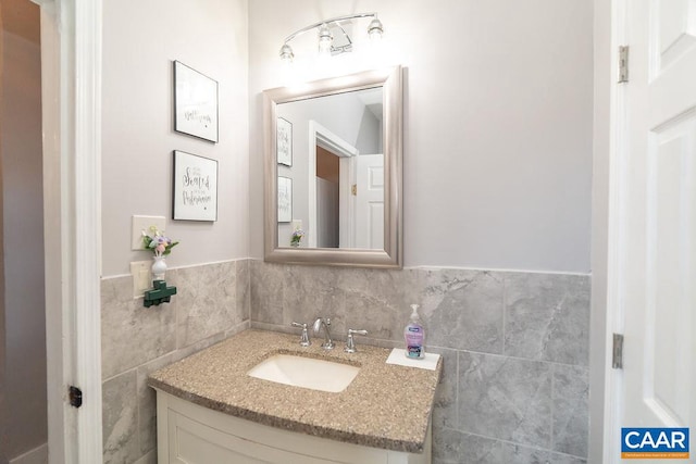 bathroom with vanity and tile walls