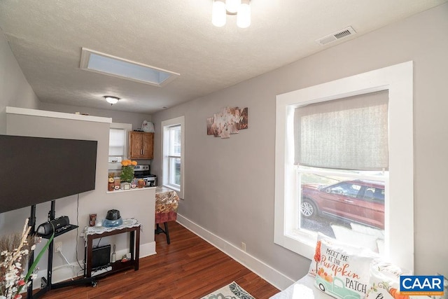 interior space featuring a textured ceiling and dark hardwood / wood-style flooring