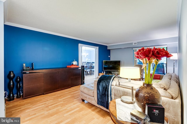 living room with ornamental molding and hardwood / wood-style floors