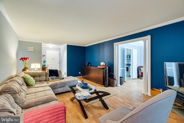 living room with ornamental molding and hardwood / wood-style flooring