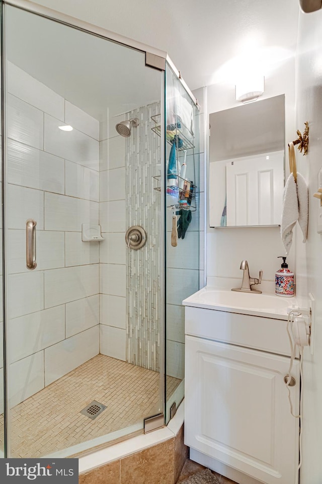 bathroom featuring vanity and a shower with shower door