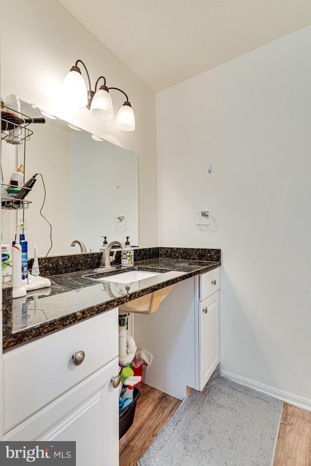 bathroom with vanity and hardwood / wood-style floors