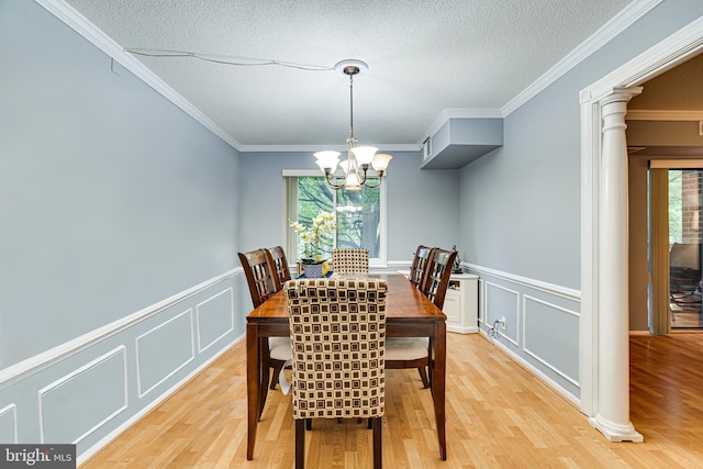 dining room featuring light hardwood / wood-style flooring, a healthy amount of sunlight, and crown molding