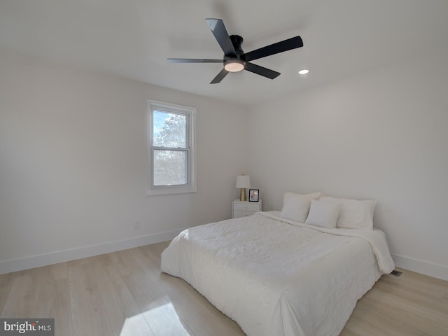 bedroom featuring light wood-type flooring and ceiling fan