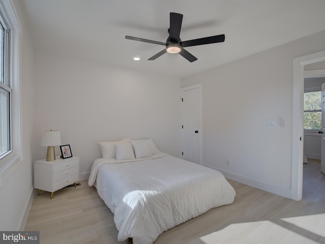 bedroom with ceiling fan and light wood-type flooring