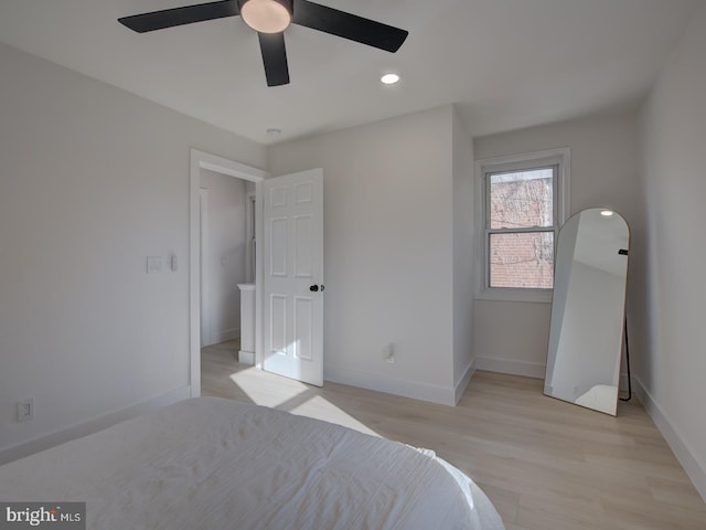 bedroom with light hardwood / wood-style floors and ceiling fan