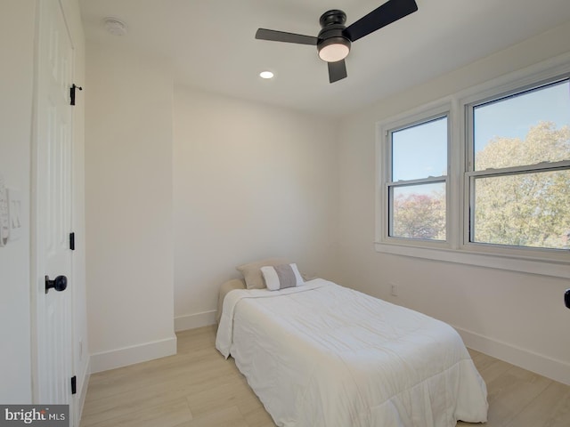 bedroom with light wood-type flooring and ceiling fan