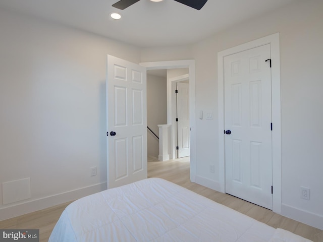 bedroom with ceiling fan and light hardwood / wood-style floors