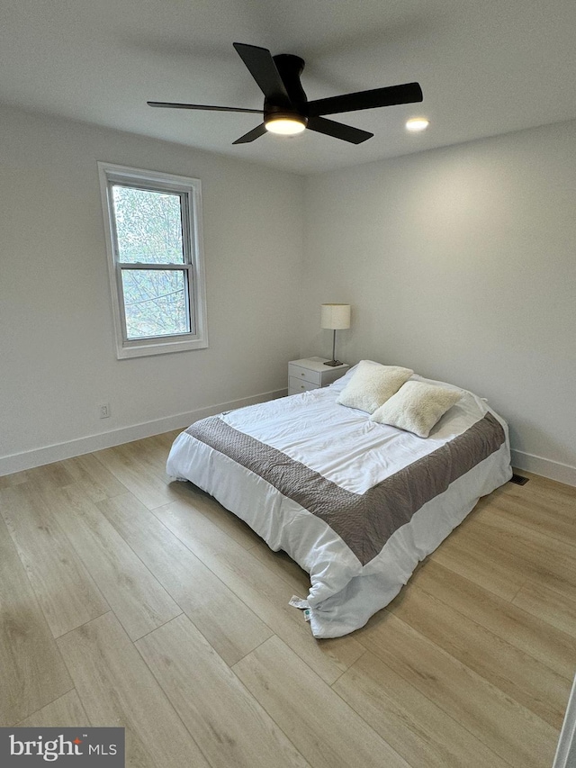 bedroom featuring ceiling fan and light hardwood / wood-style flooring