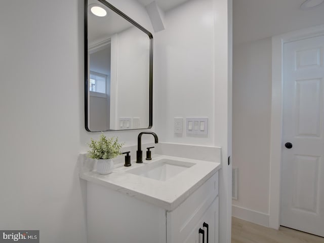 bathroom featuring vanity and hardwood / wood-style flooring