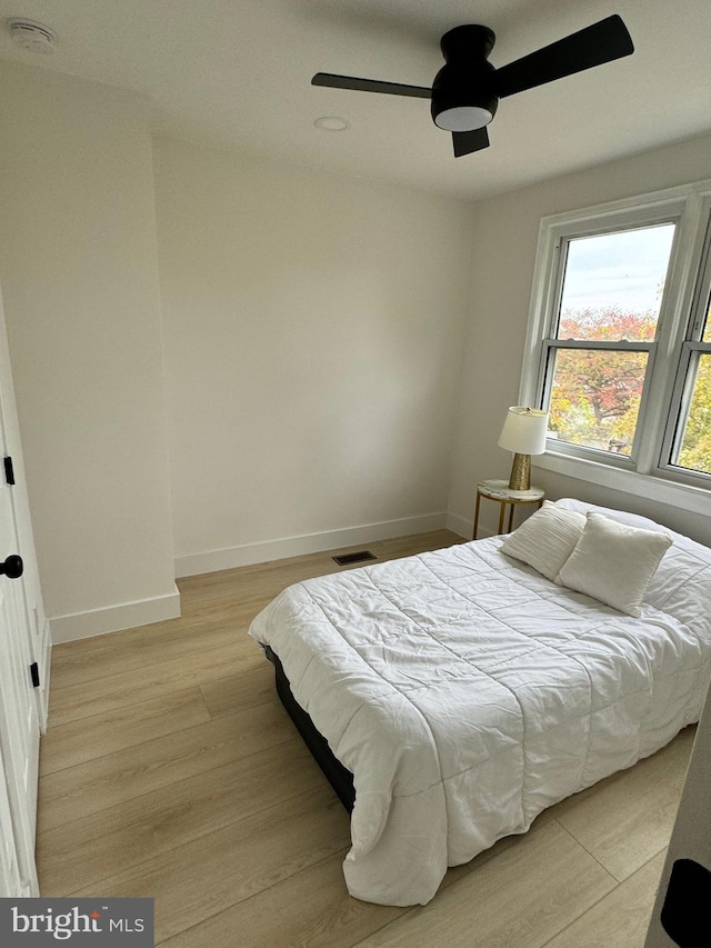 bedroom featuring ceiling fan and light hardwood / wood-style flooring