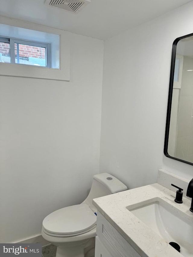 bathroom featuring vanity and toilet