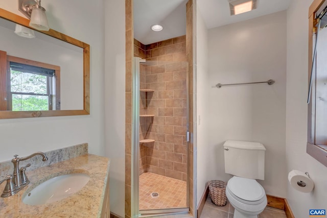 bathroom featuring a shower with door, toilet, tile patterned flooring, and vanity